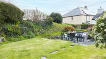 The large south-facing back garden is perfect for al fresco dining. 