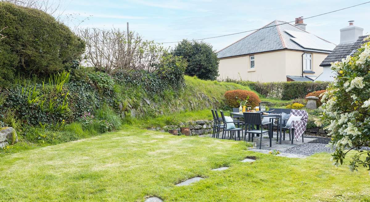 The large south-facing back garden is perfect for al fresco dining. 