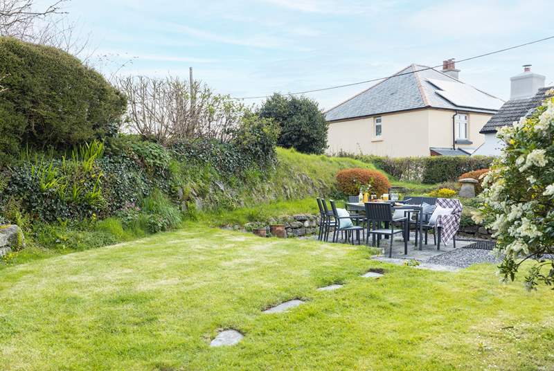 The large south-facing back garden is perfect for al fresco dining. 