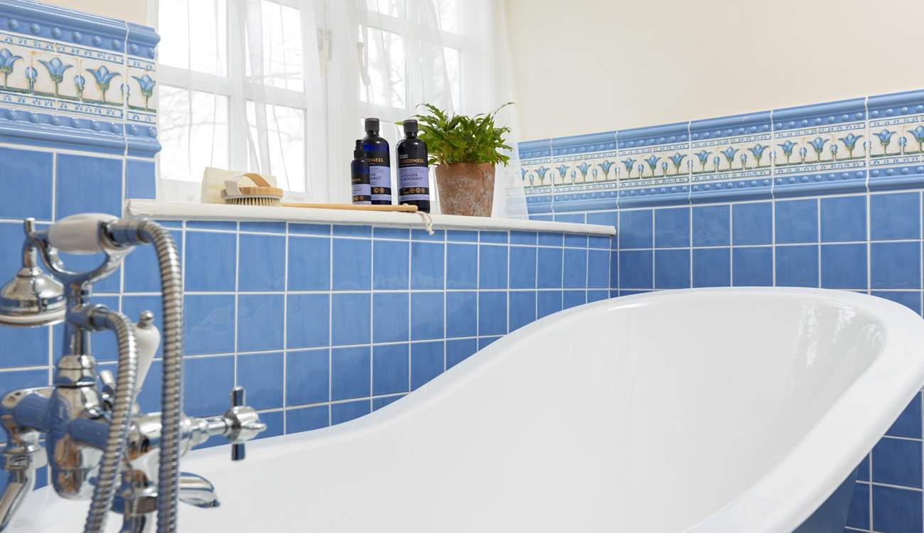 The family bathroom has a feature roll-top bath and a separate shower cubicle.