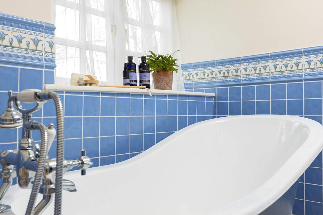 The family bathroom has a feature roll-top bath and a separate shower cubicle.