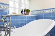 The family bathroom has a feature roll-top bath and a separate shower cubicle.