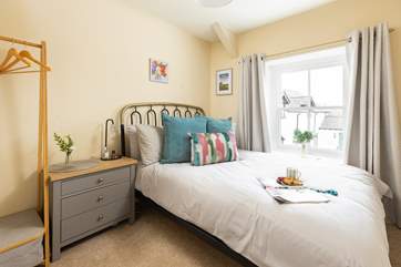 Pretty bedroom three has a double bed.