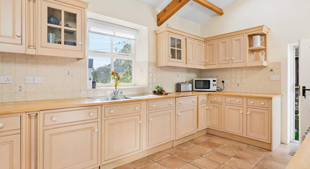 The kitchen is light and bright with a lovely view from the kitchen window out to the garden.