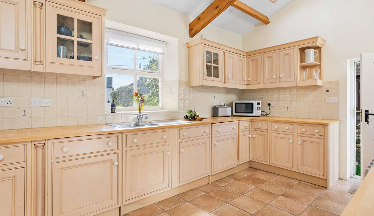 The kitchen is light and bright with a lovely view from the kitchen window out to the garden.