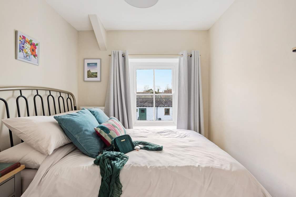 Pretty bedroom three has a double bed.
