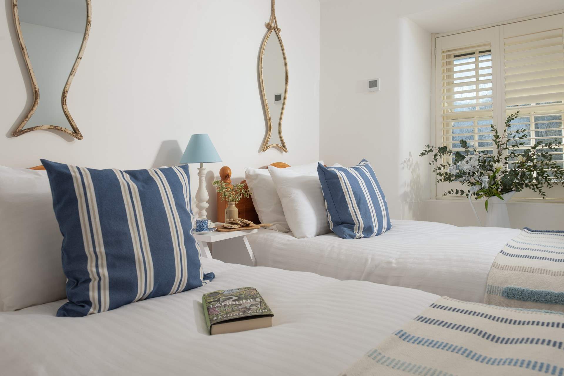 Lovely linens, cushions and throws adorn the beds.