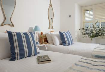 Lovely linens, cushions and throws adorn the beds.