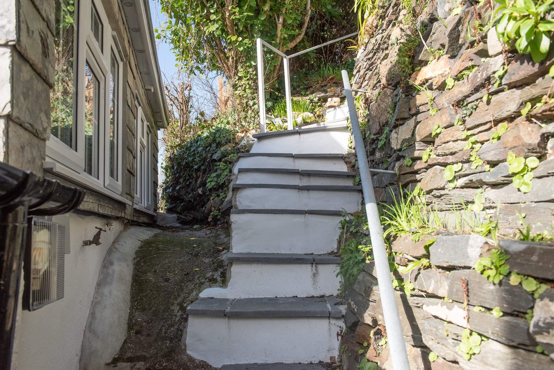 Slate steps lead up to the terraced garden.