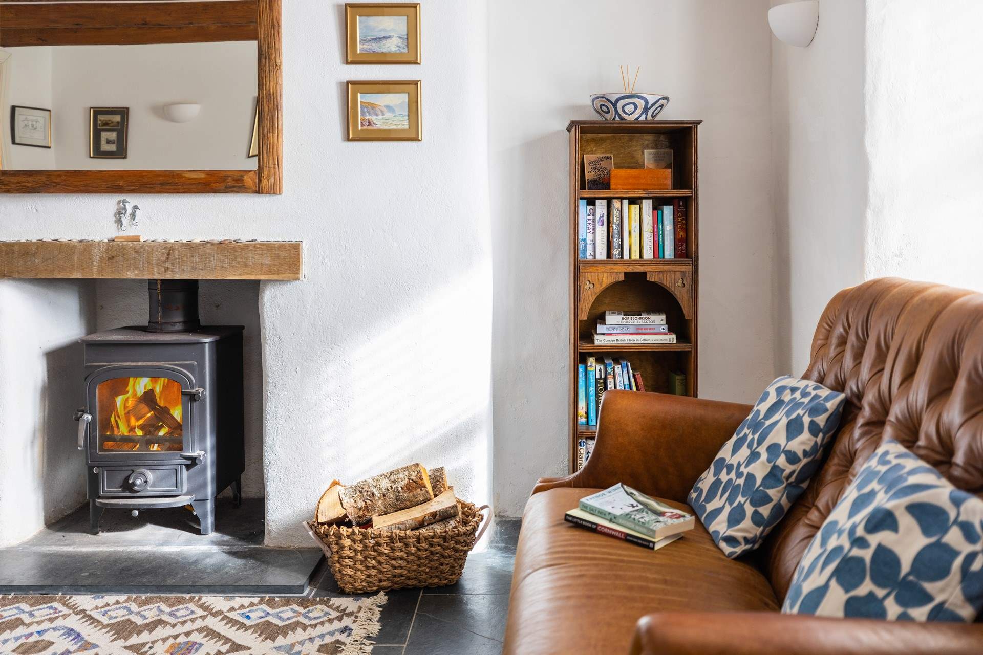 This super stylish room is perfect for catching up on a holiday read in front of the wood-burner.