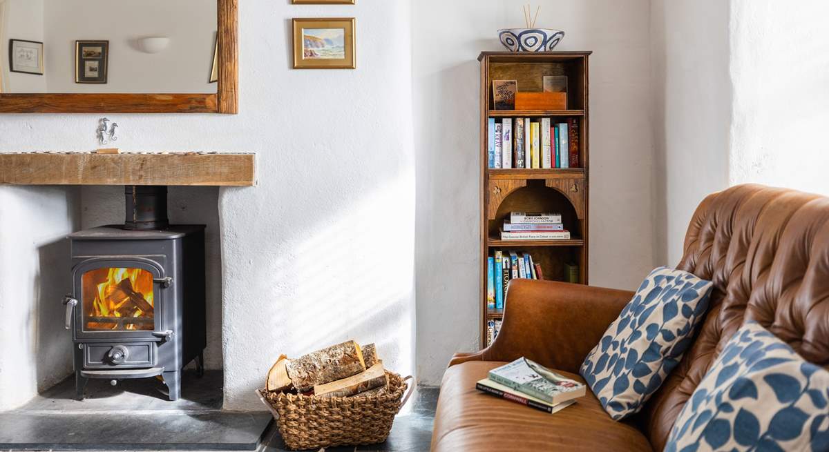 This super stylish room is perfect for catching up on a holiday read in front of the wood-burner.