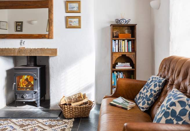 This super stylish room is perfect for catching up on a holiday read in front of the wood-burner.