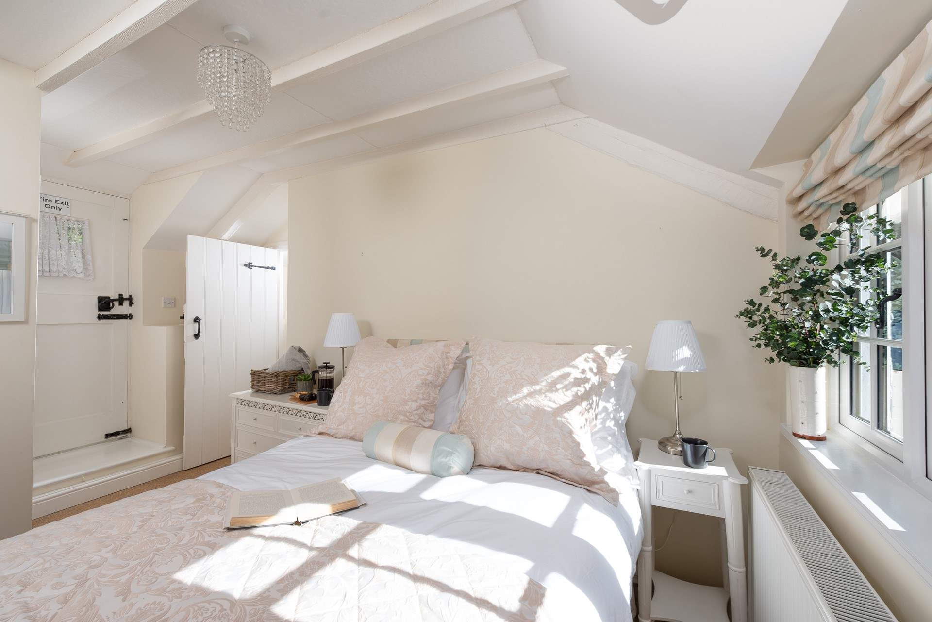 Lovely linens, cushions and throws adorn the bed in bedroom one.