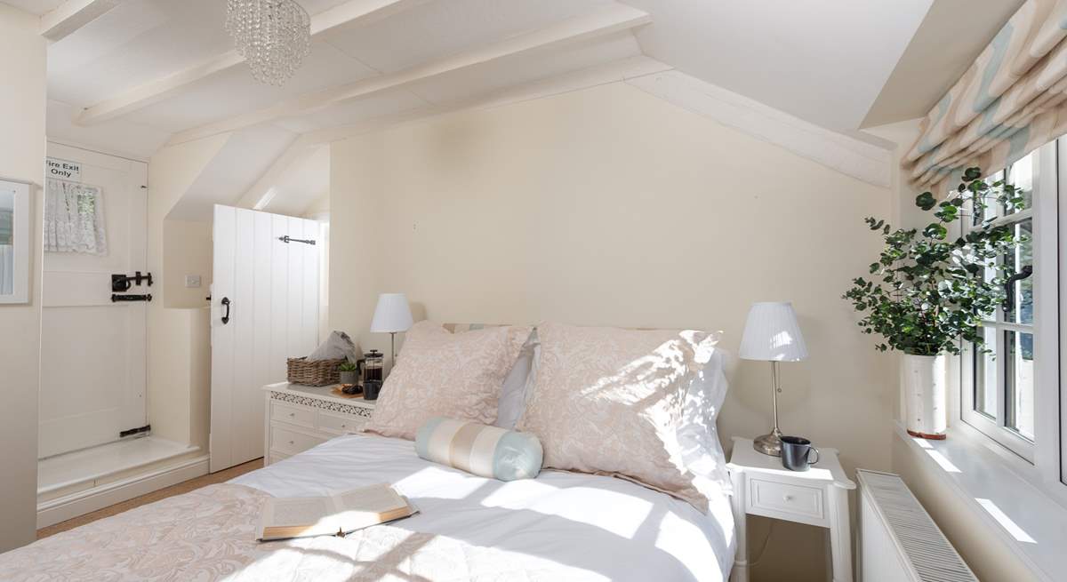 Lovely linens, cushions and throws adorn the bed in bedroom one.