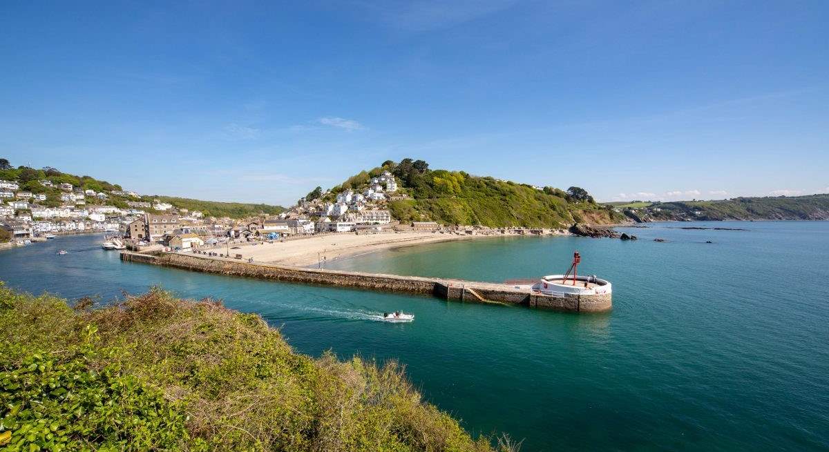 Grab some fish and chips in the town of Looe, best enjoyed sitting on the Banjo Pier that juts out into the sparkling sea.