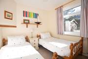 Bringing joy and imagination to bedtime, this twin bedroom is the perfect retreat for young guests.