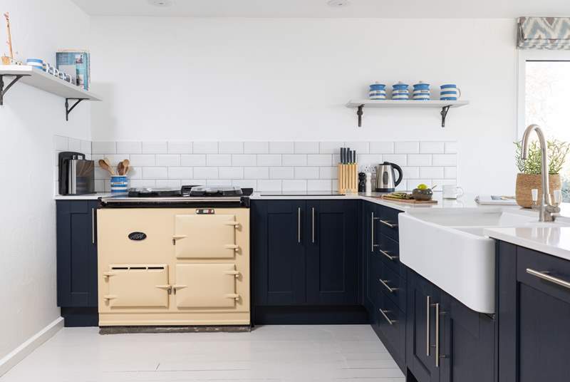 The stunning kitchen is home to an electric Aga, electric oven and combination microwave. 