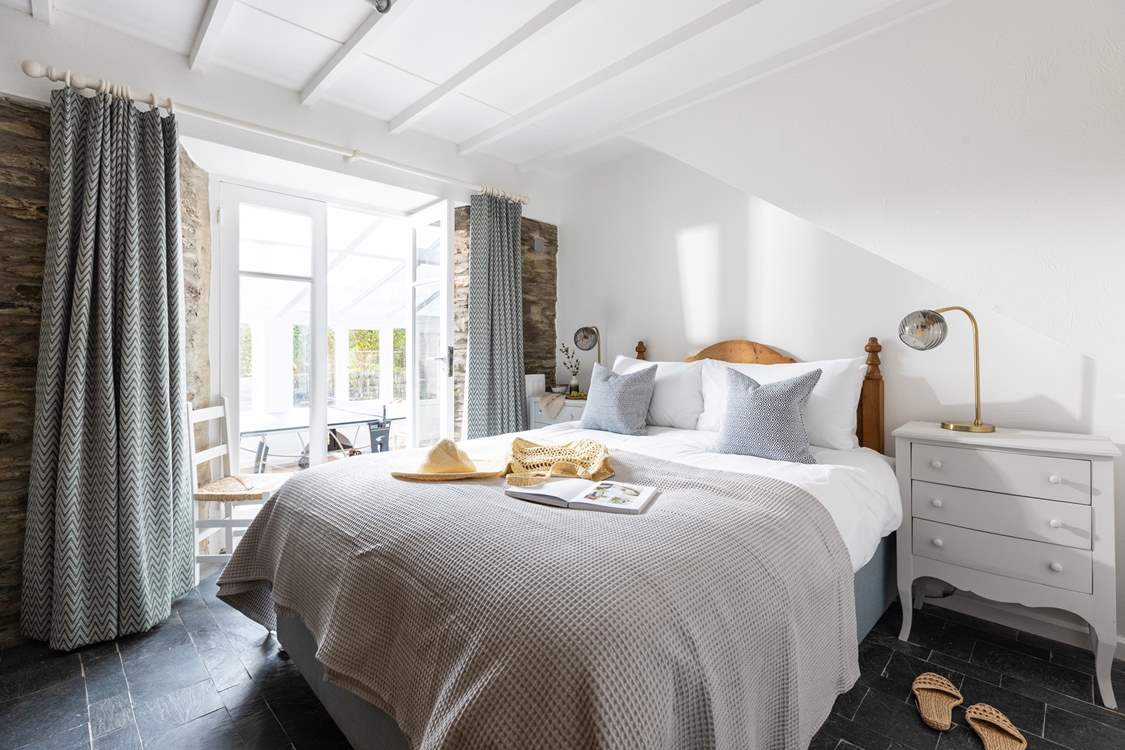 Bedroom 2 is beautifully furnished and has French doors into the conservatory.