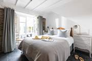 Bedroom 2 is beautifully furnished and has French doors into the conservatory.