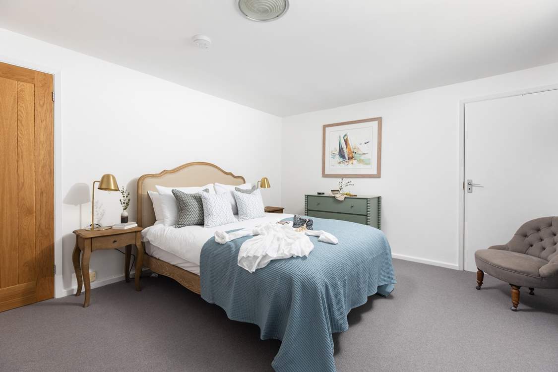 Elegant bedroom 5 has a king-size double bed for a restful night.