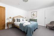 Elegant bedroom 5 has a king-size double bed for a restful night.