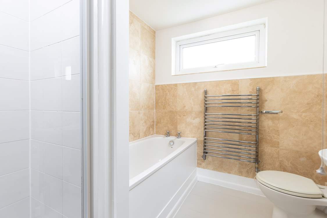 The ground floor bathroom has a shower cubicle and a bath.