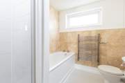 The ground floor bathroom has a shower cubicle and a bath.