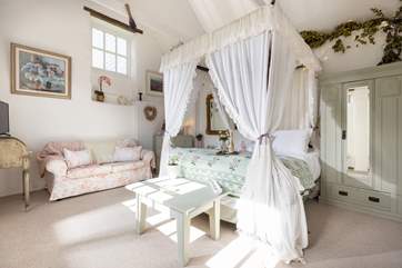 Pretty as a picture, the bedroom is delightful.