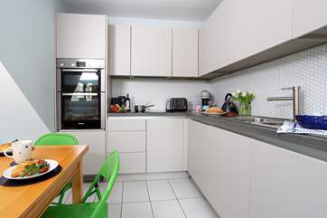 Sleek clean lines of the kitchen/dining-room.