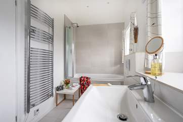The family bathroom has a bath with shower over.