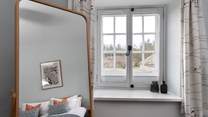 The hanging rail is cleverly hidden behind the mirror.