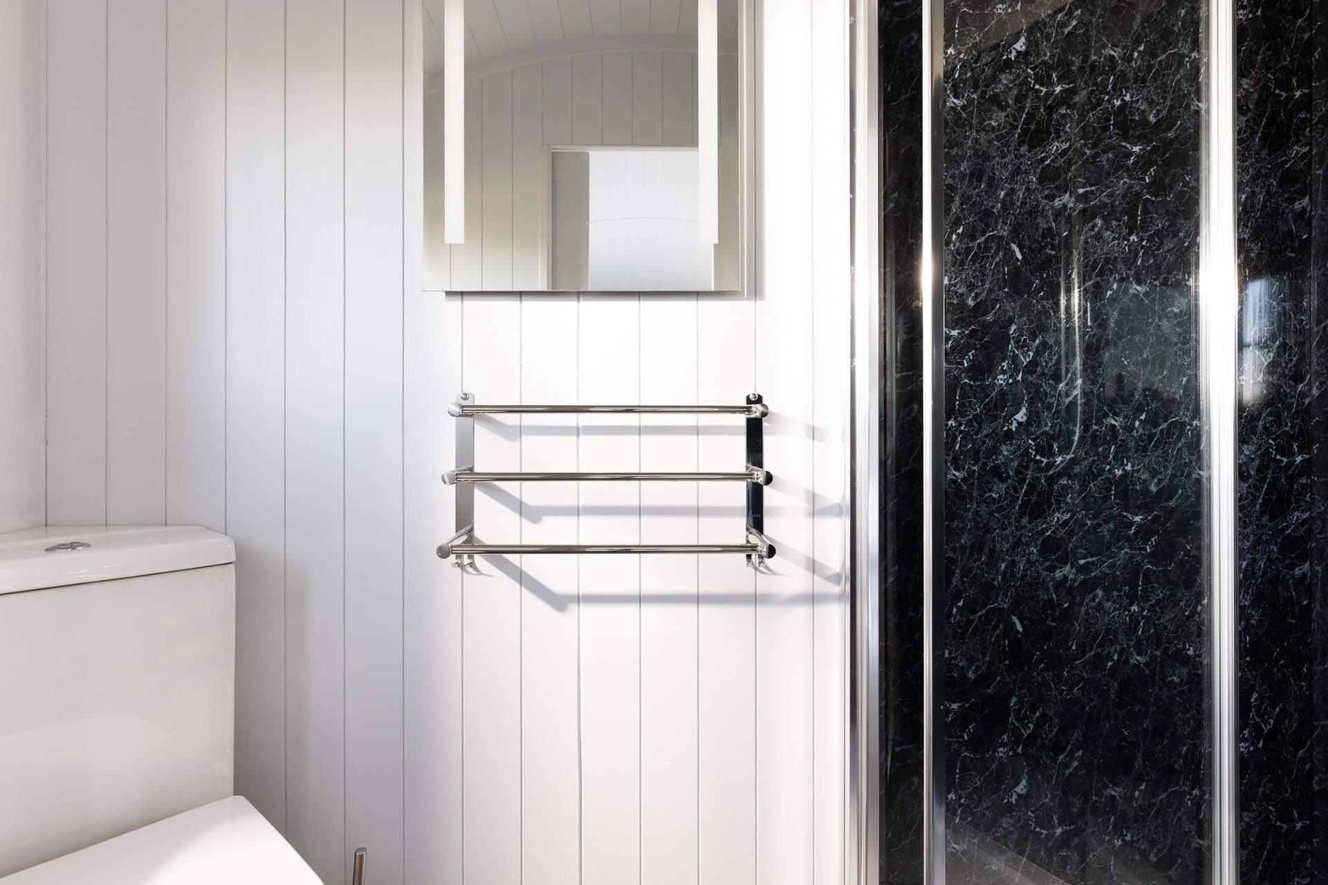 The en suite shower-room is sleek and simplistic. 