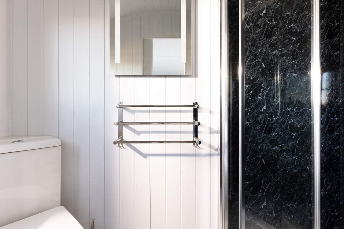 The en suite shower-room is sleek and simplistic.