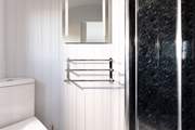 The en suite shower-room is sleek and simplistic.