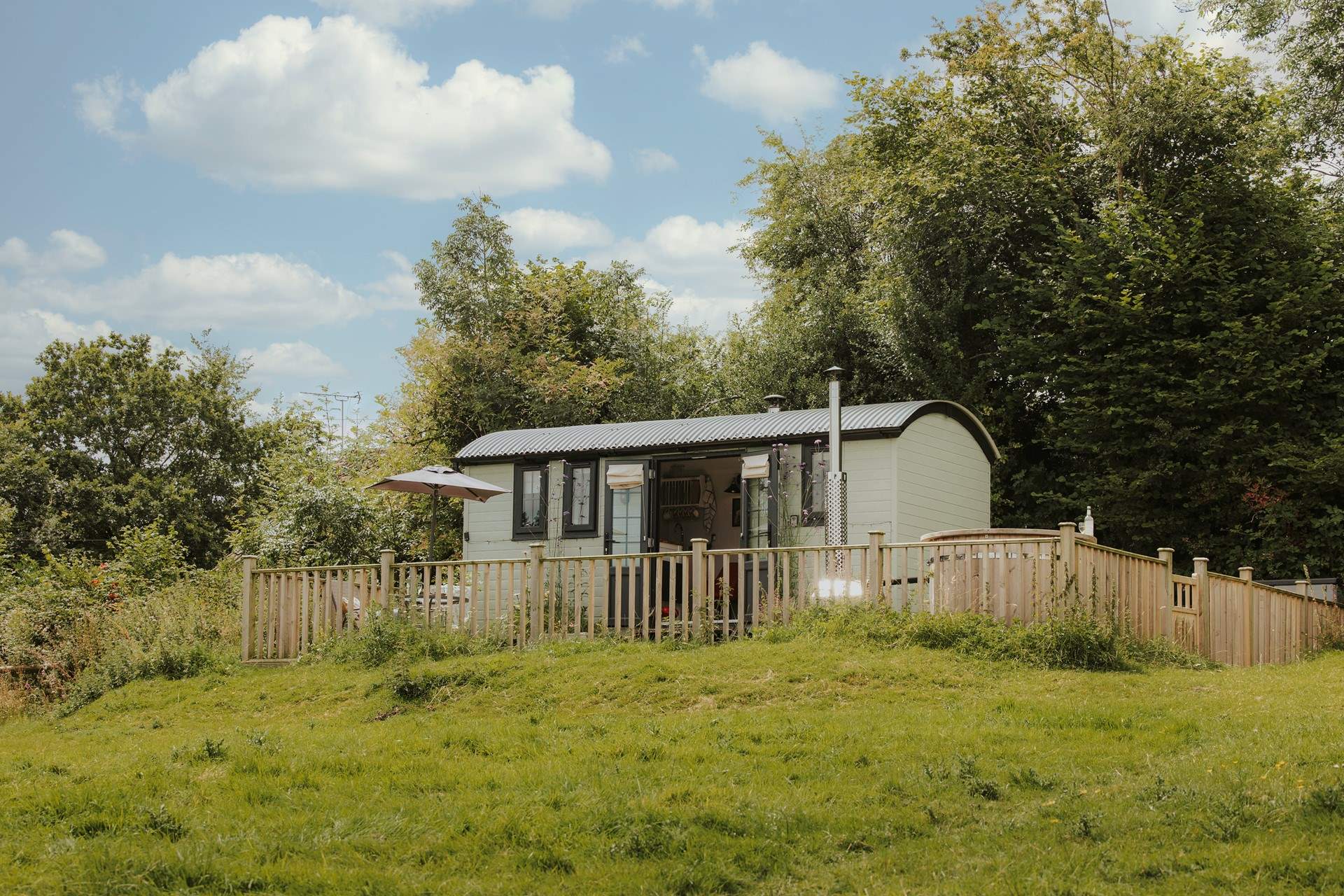 Perched atop a meadow, this hideaway boasts idyllic countryside views. 