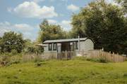 Perched atop a meadow, this hideaway boasts idyllic countryside views.
