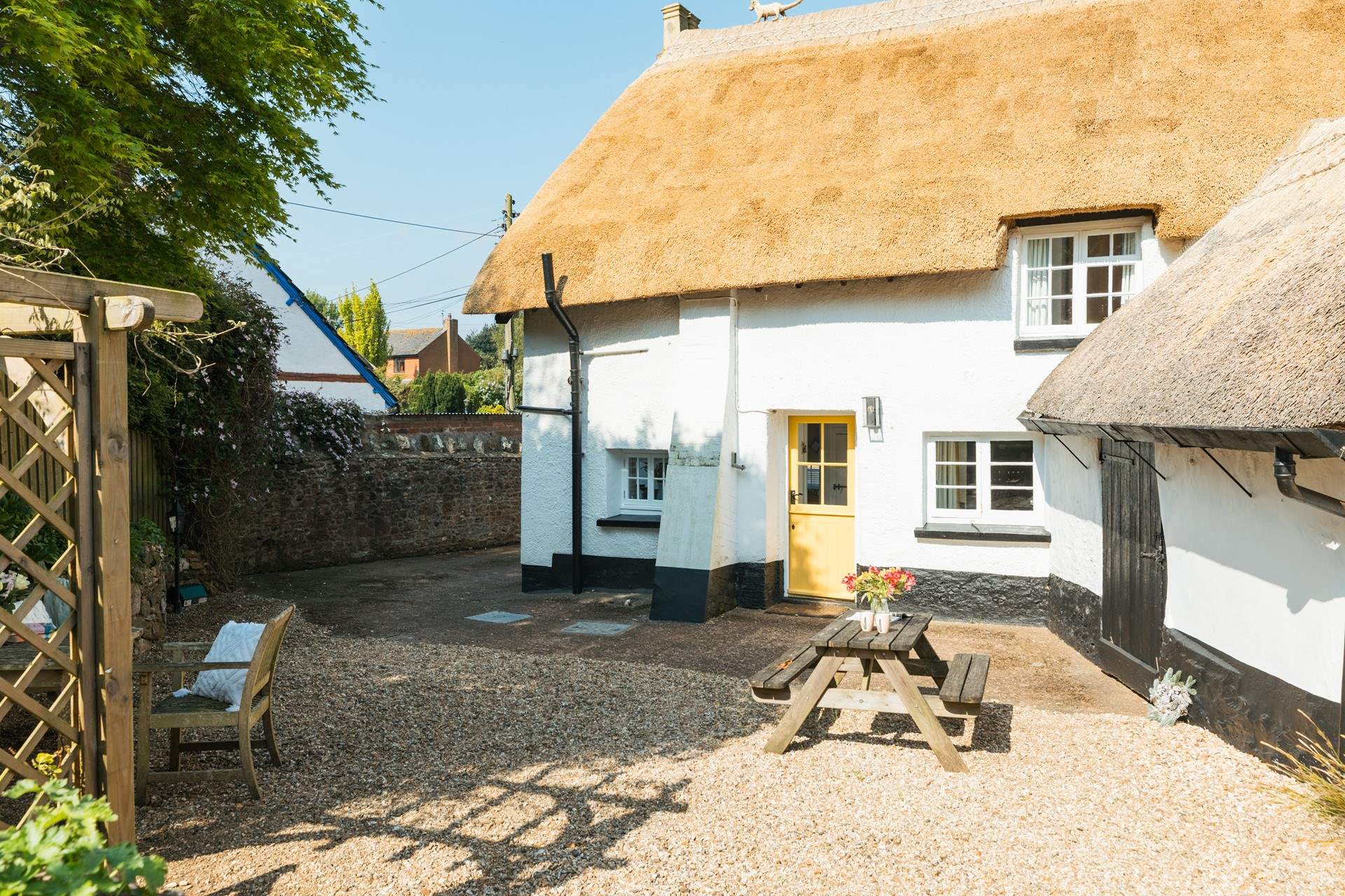 The gorgeous thatch looking golden in the Devon sunshine. This is the back of the house, with parking and a picnic table.