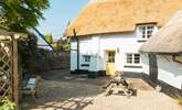 The gorgeous thatch looking golden in the Devon sunshine. This is the back of the house, with parking and a picnic table. - Thumbnail Image