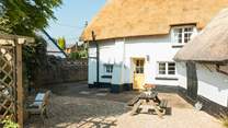 The gorgeous thatch looking golden in the Devon sunshine. This is the back of the house, with parking and a picnic table.