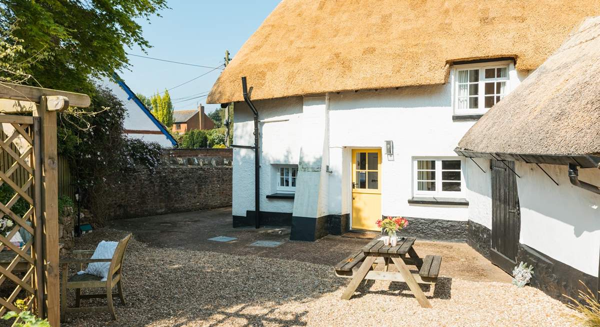 The gorgeous thatch looking golden in the Devon sunshine. This is the back of the house, with parking and a picnic table.