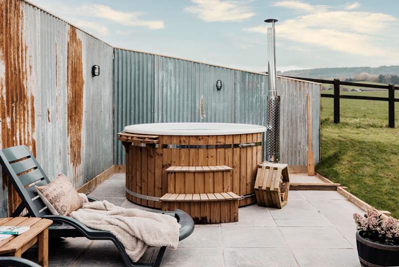 The luxurious secluded hot tub boasts tranquil views of sweeping countryside vistas.