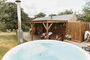 Boasting a secluded wood-fired hot tub and tranquil views of sweeping countryside vistas.