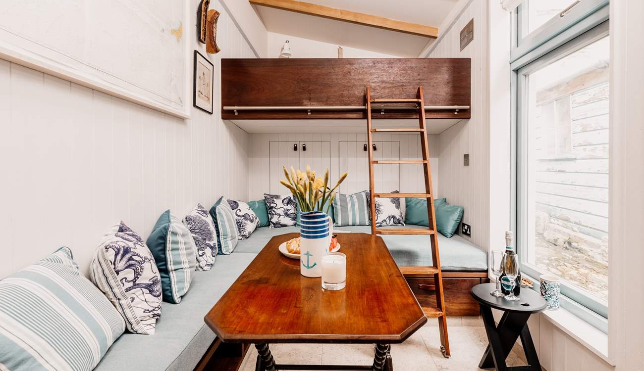 The table folds away and hangs on the wall to save space. 
