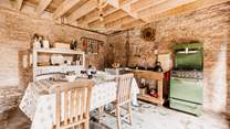 The rustic kitchen is well-equipped for your unique stay in nature. 