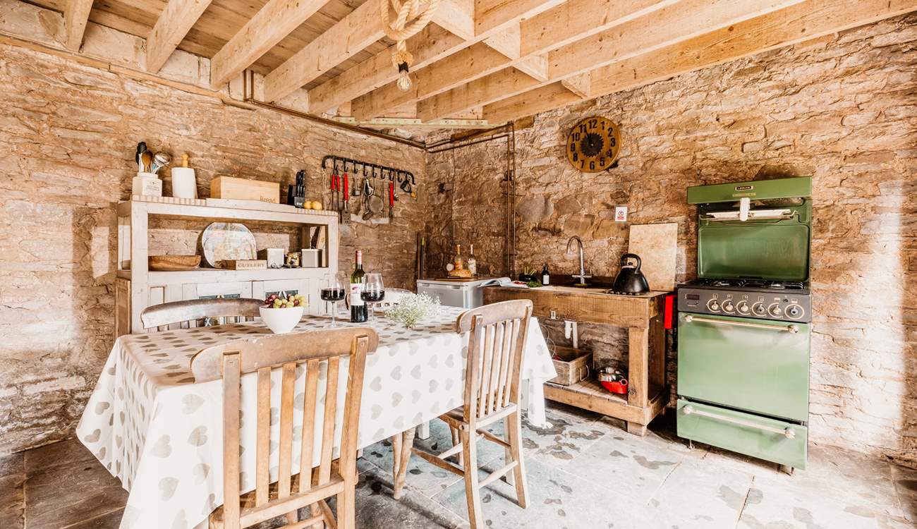 The rustic kitchen is well-equipped for your unique stay in nature. 