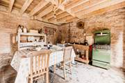 The rustic kitchen is well-equipped for your unique stay in nature.