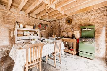 The rustic kitchen is well-equipped for your unique stay in nature.