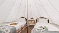 You'll find two single beds in the bell tent.