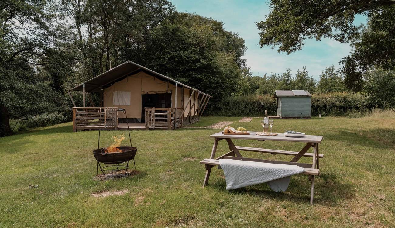 The separate shower-room sits to the right of the safari tent.