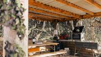 The outdoor kitchen offers the ultimate al fresco dining experience.